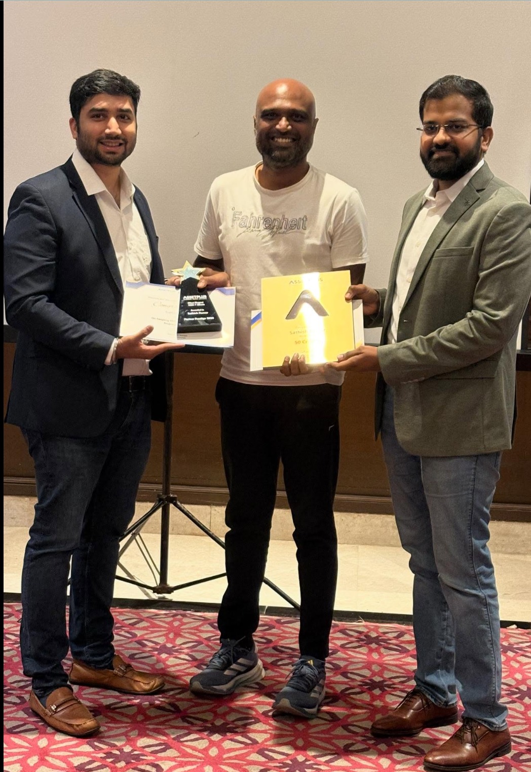 Sathish receiving the AssetPlus award on stage
